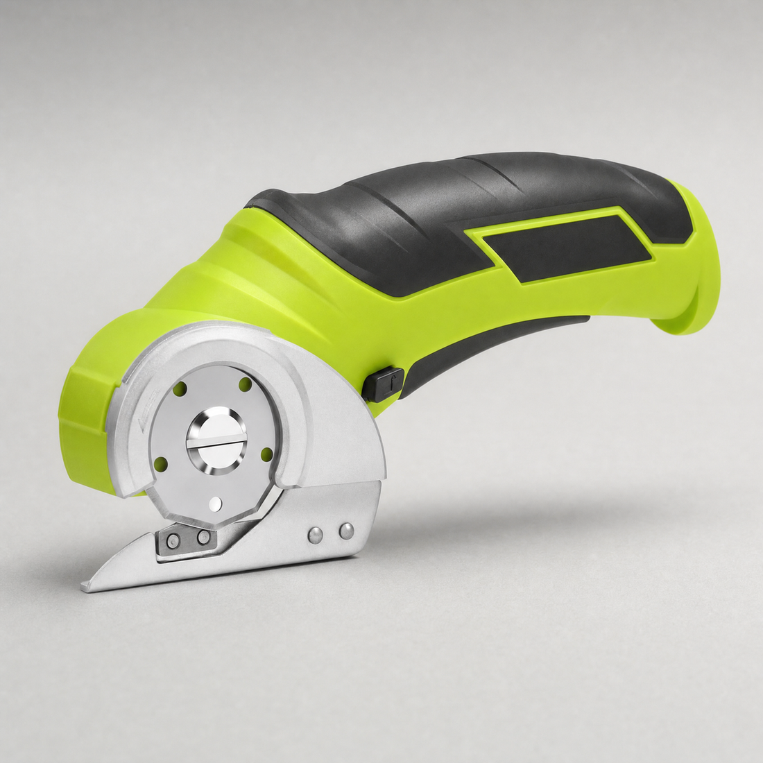 The cordless rotary cutter, lime green and black, with its circular blade and guard