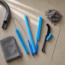 Vacuum flatlay: the kit with a towel, a vacuum hose, a pile of lint and the straightened coat hanger it replaces