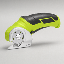 The cordless rotary cutter, lime green and black, with its circular blade and guard